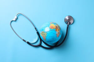 Globe with stethoscope isolated on blue background. Save the wold, Global healthcare and Green Earth day concept.